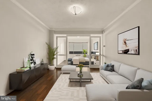 a living room with furniture wooden floor and a large window