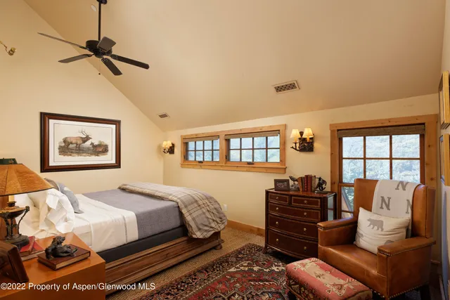 a bedroom with bed couch and window