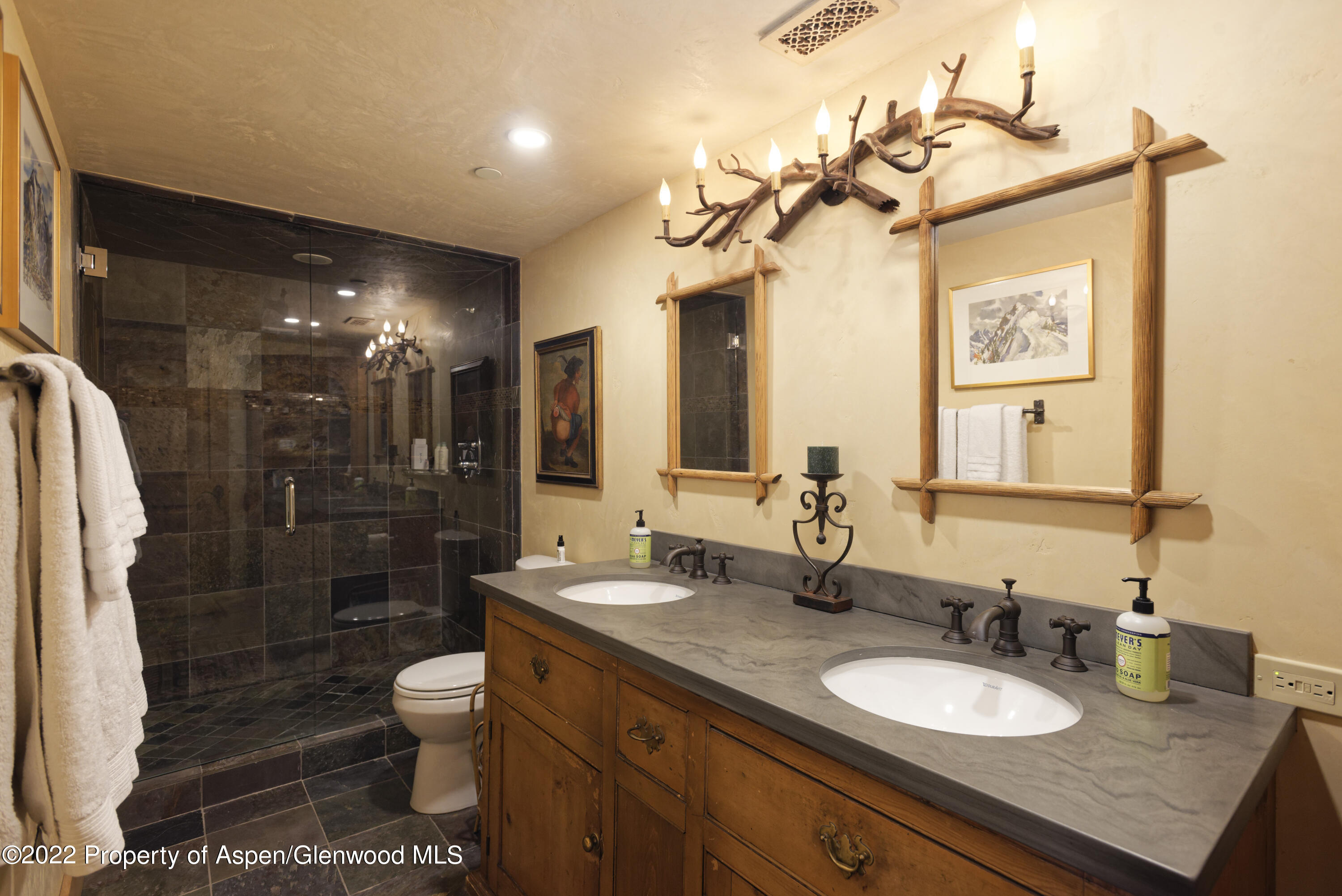 301 Stone Road Basalt, CO 81621 - Photo 23 of 45 a bathroom with a granite countertop sink toilet a mirror a vanity and shower