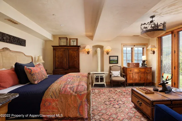 a bedroom with furniture and a chandelier