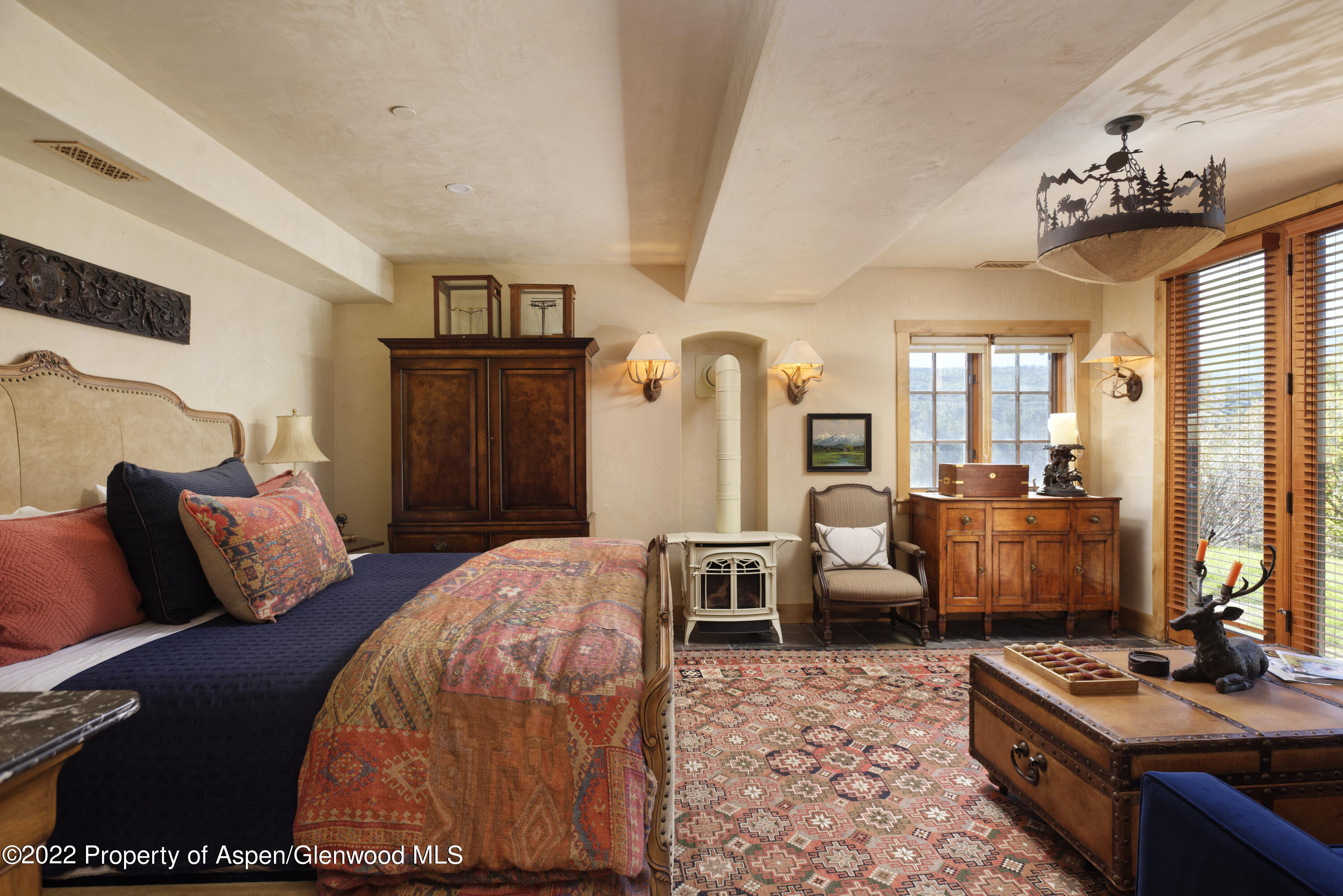301 Stone Road Basalt, CO 81621 - Photo 24 of 45 a bedroom with furniture and a chandelier