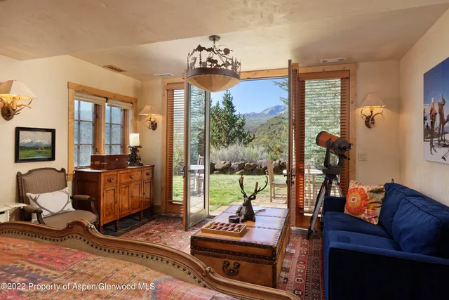 a living room with furniture and a floor to ceiling window