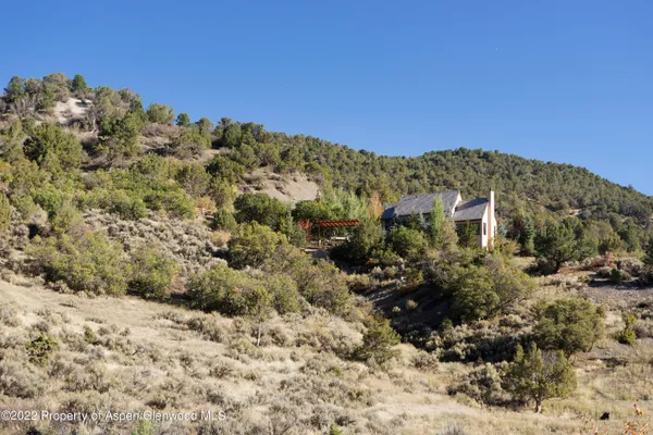 a view of a large building with mountains in the background