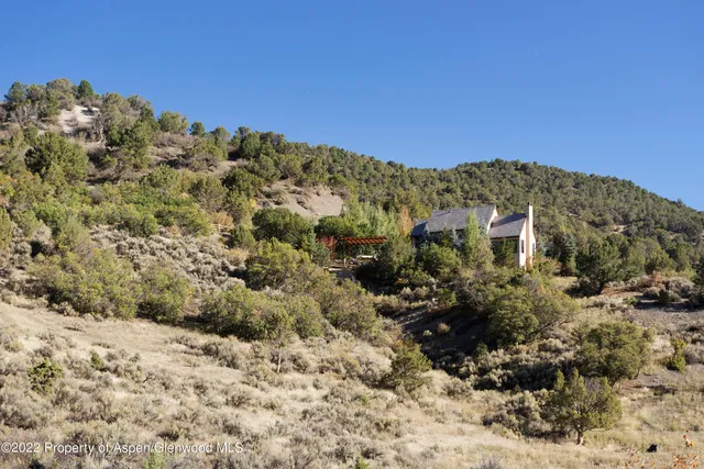 a view of a large building with mountains in the background