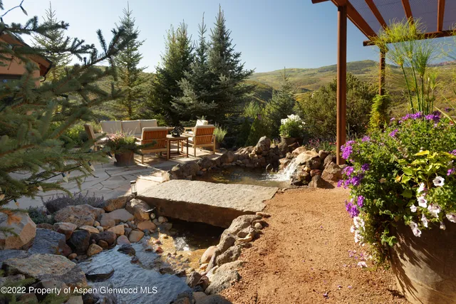 a view of a patio with table and chairs and potted plants