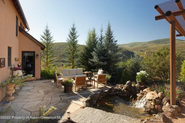 a view of a patio with table and chairs with wooden floor and fence