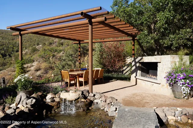 a terrace with outdoor seating and trees