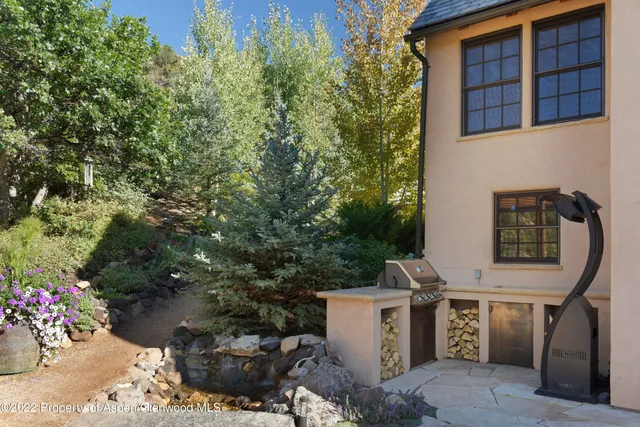 a view of a patio with table and chairs and potted plants