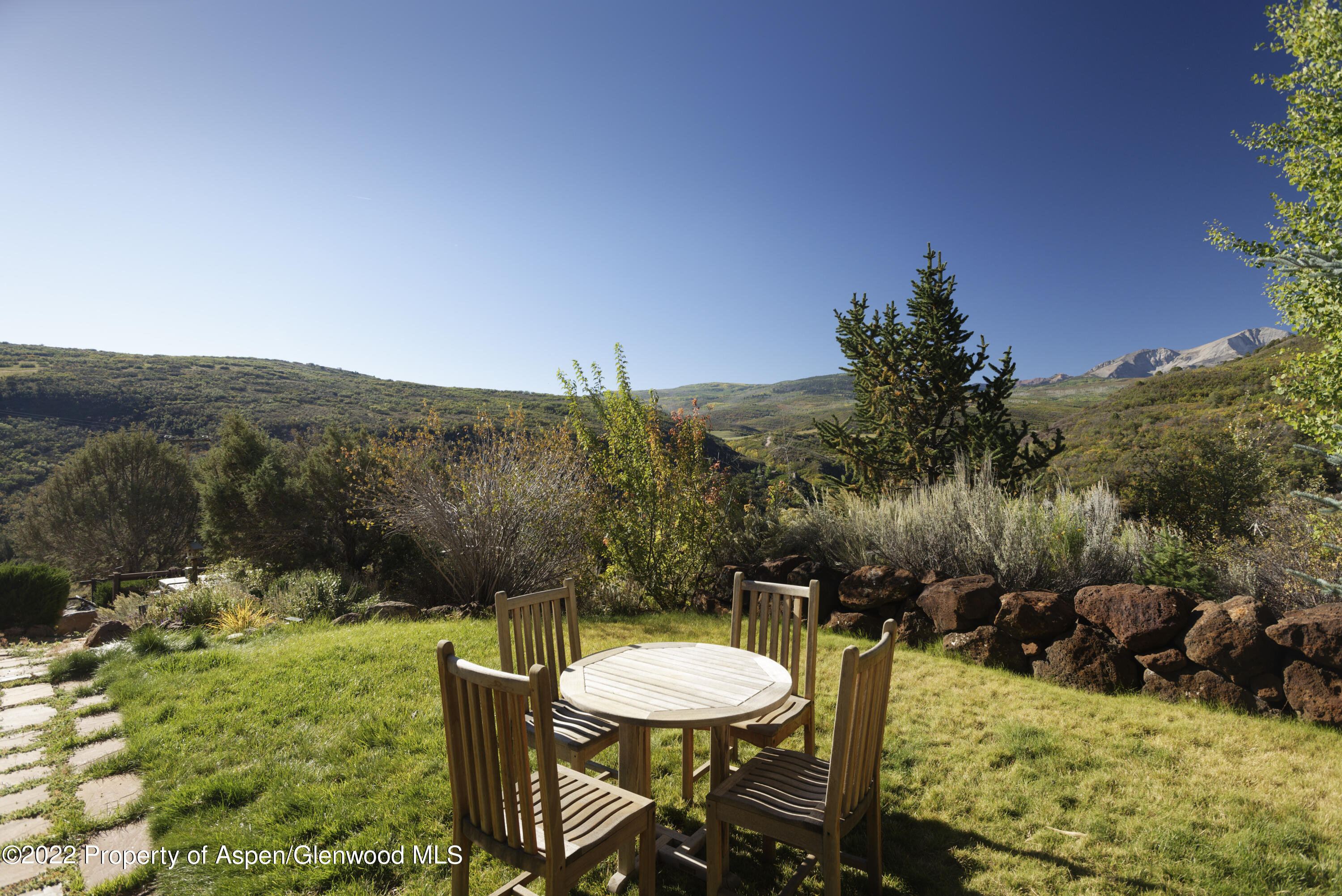 301 Stone Road Basalt, CO 81621 - Photo 38 of 45 a view of a swimming pool with a table and chairs