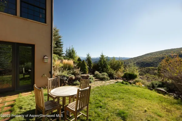 a view of a chairs and table in patio