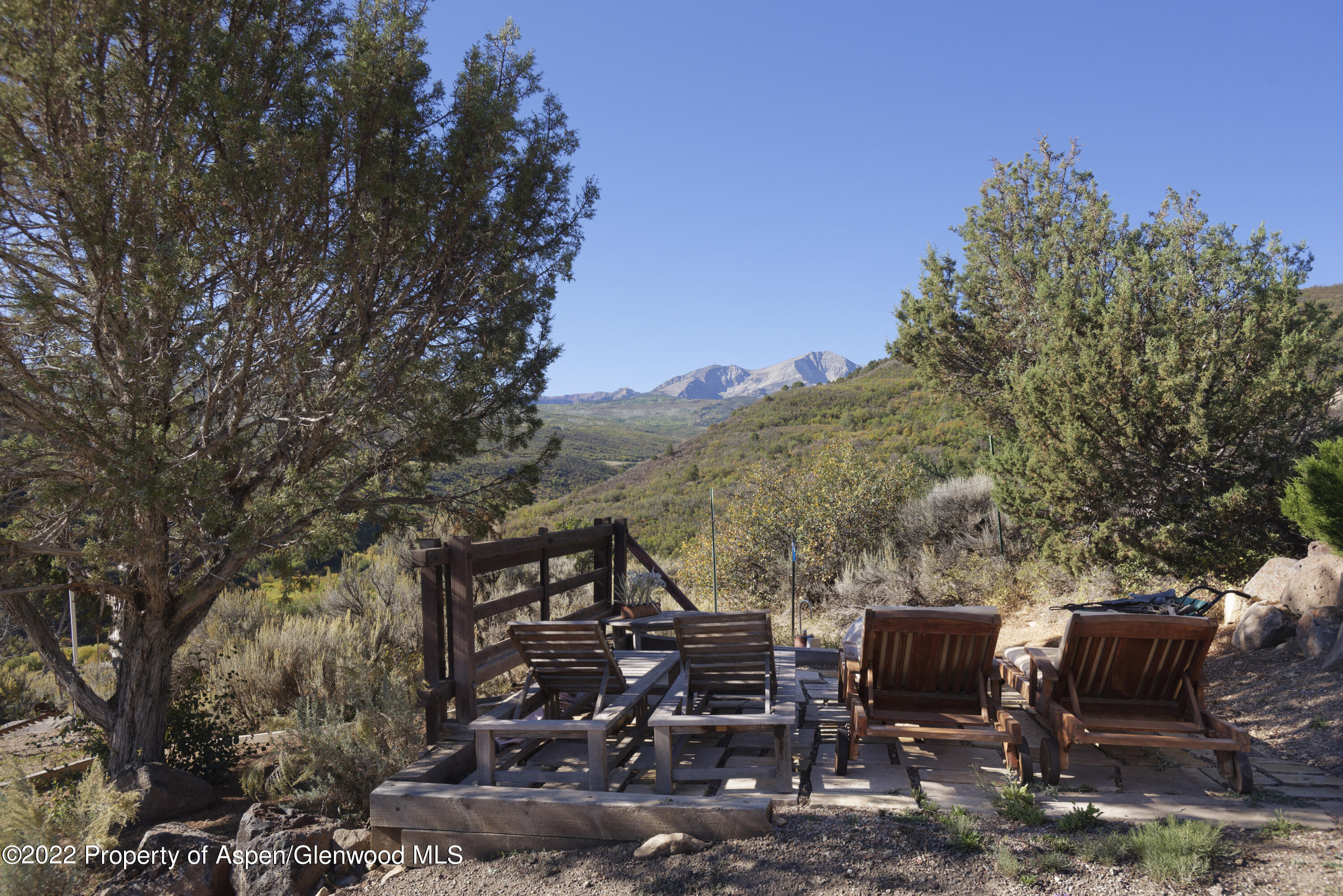 301 Stone Road Basalt, CO 81621 - Photo 43 of 45 a view of a patio with table and chairs with wooden fence and plants