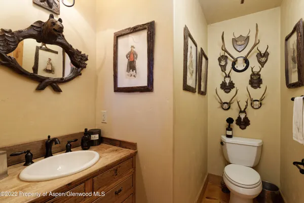 a bathroom with a toilet sink and mirror