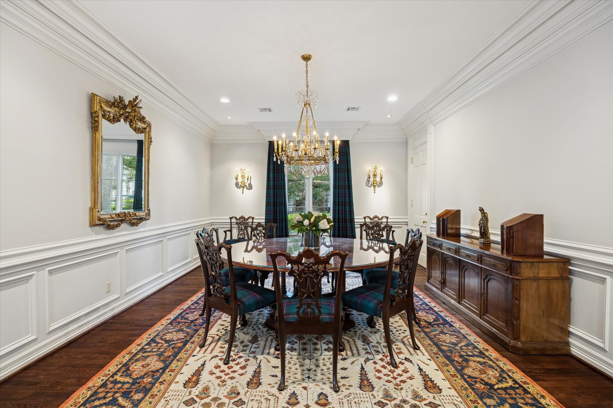 2249 Pelham Drive Houston, TX 77019 - Photo 17 of 50 Spacious dining room accented with ornate lighting, refined millwork, and classic furnishings, creating an elegant setting for formal gatherings and celebrations.