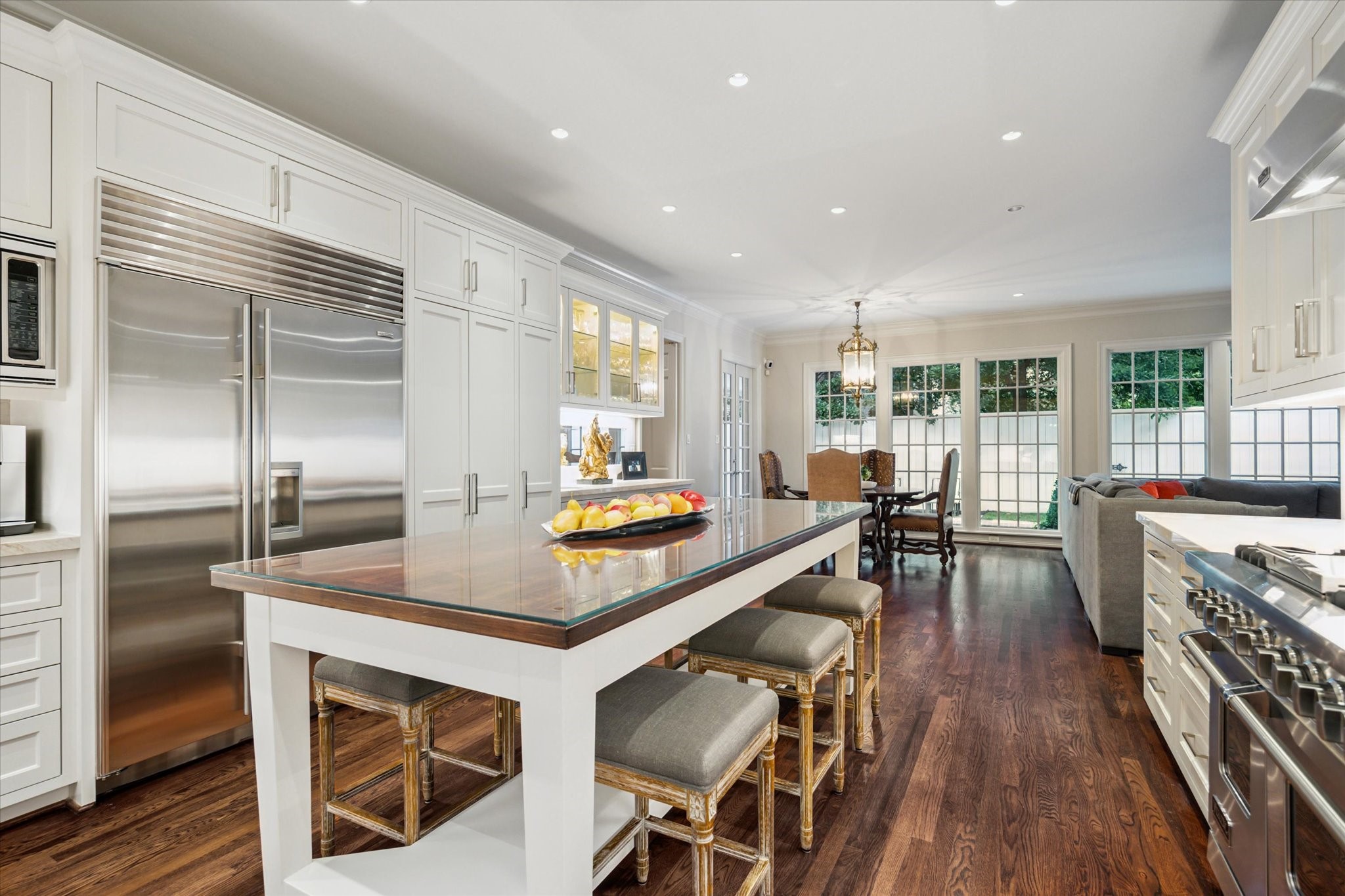 2249 Pelham Drive Houston, TX 77019 - Photo 24 of 50 Sleek built-in refrigeration and abundant storage elevate the kitchen’s design.