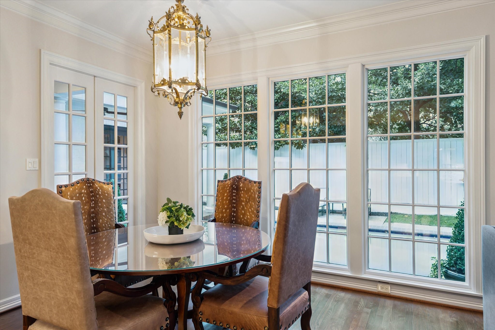2249 Pelham Drive Houston, TX 77019 - Photo 27 of 50 Sunlit breakfast area with panoramic backyard views and elegant chandelier.