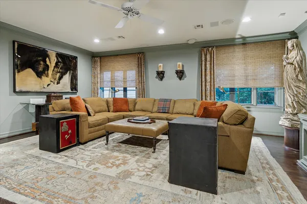 a living room with furniture ceiling fan and a rug