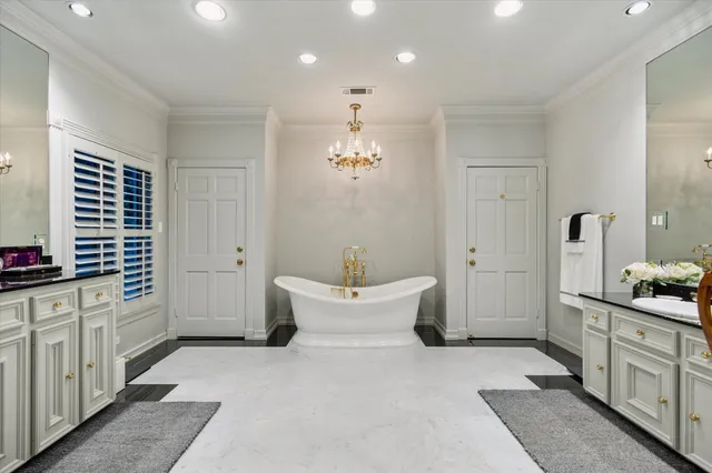 a spacious bathroom with double vanity and a bathtub