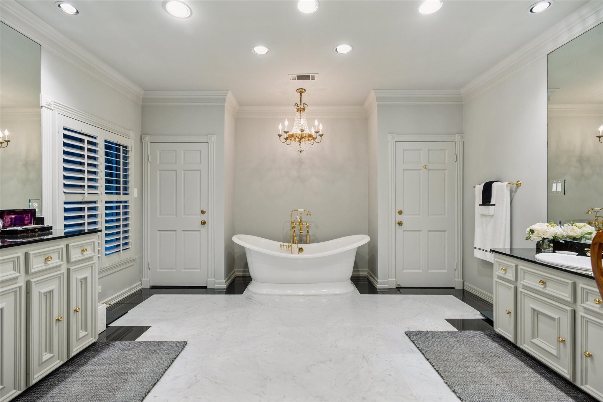 2249 Pelham Drive Houston, TX 77019 - Photo 33 of 50 Luxurious bath with freestanding tub, chandelier, and dual vanities.