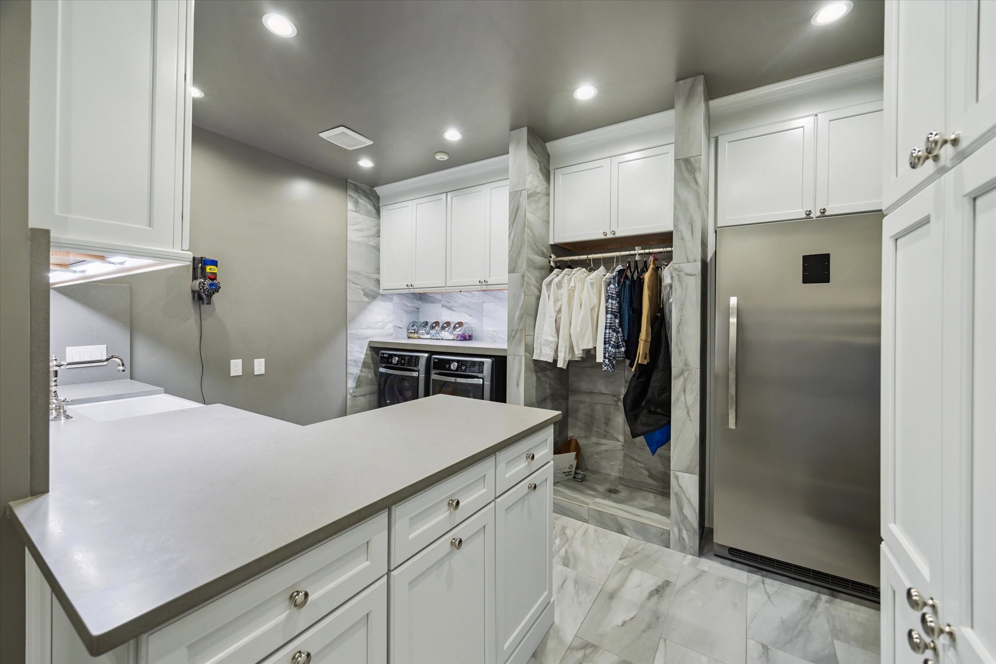2249 Pelham Drive Houston, TX 77019 - Photo 37 of 50 Well-appointed laundry room with ample cabinetry, sink, and workspace.