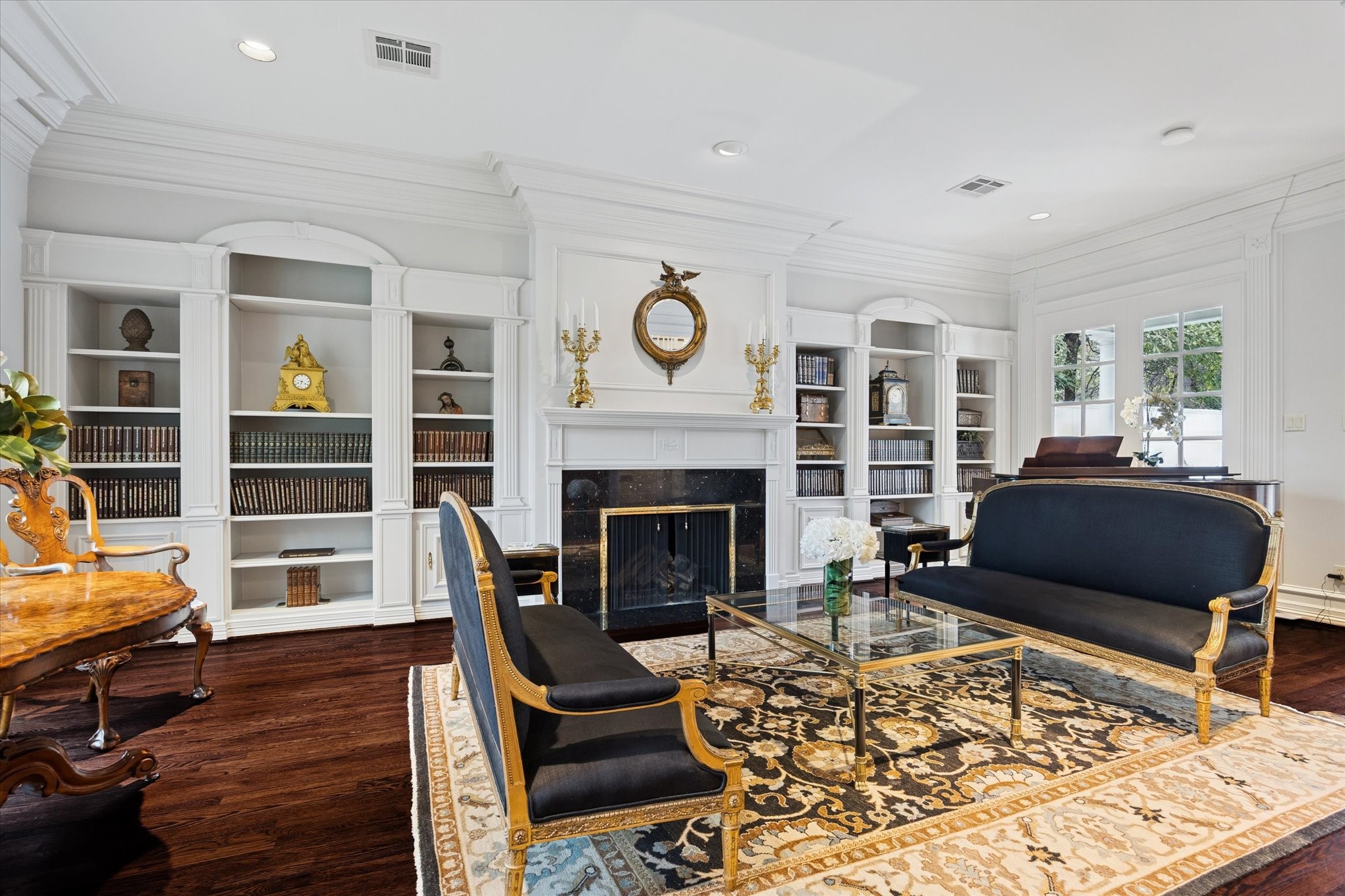 2249 Pelham Drive Houston, TX 77019 - Photo 4 of 50 Stately entertaining space anchored by a classic fireplace, flanked by custom built-ins and framed by traditional architectural detailing.