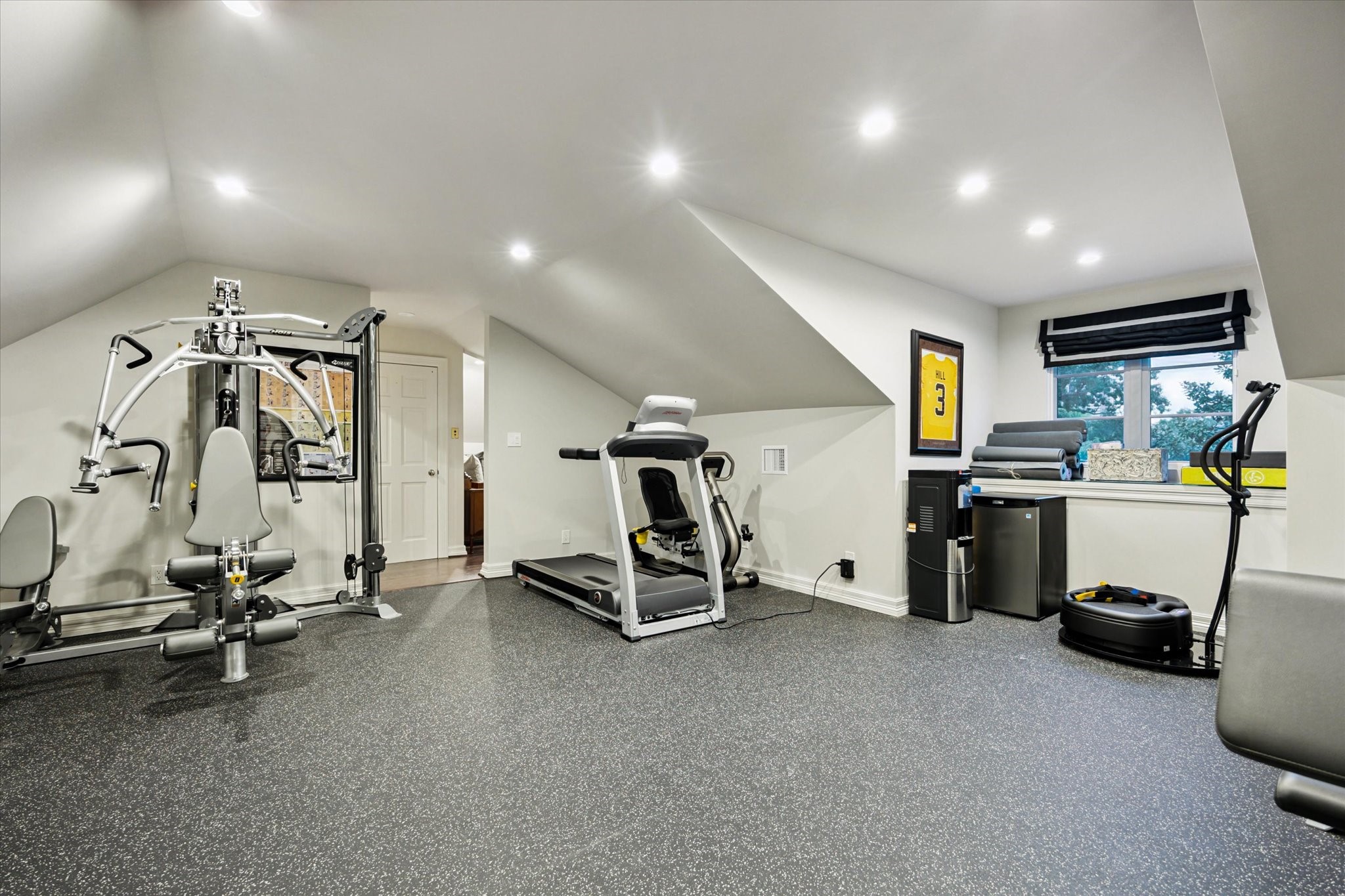 2249 Pelham Drive Houston, TX 77019 - Photo 41 of 50 Exercise room with rubber flooring and angled ceilings.