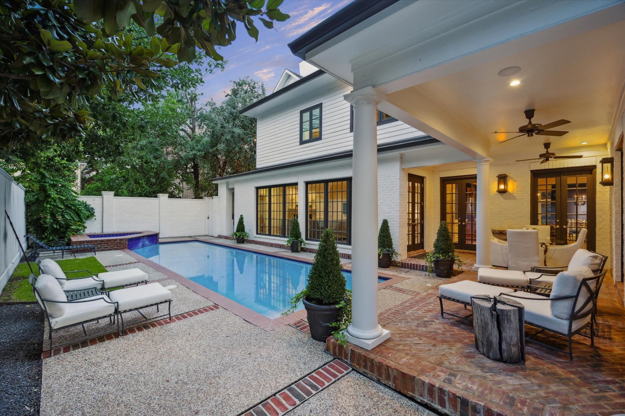 2249 Pelham Drive Houston, TX 77019 - Photo 45 of 50 Enjoy the sparkling pool and spa surrounded by a private brick and stone patio, ideal for both entertaining and relaxation.