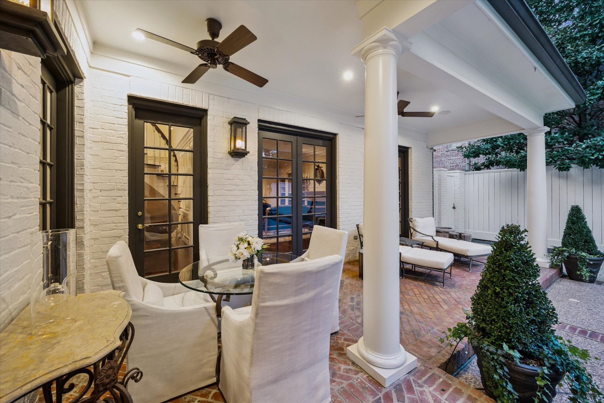 2249 Pelham Drive Houston, TX 77019 - Photo 47 of 50 Covered loggia with ceiling fans and seating areas offers a seamless indoor-outdoor lifestyle, perfect for al fresco dining.