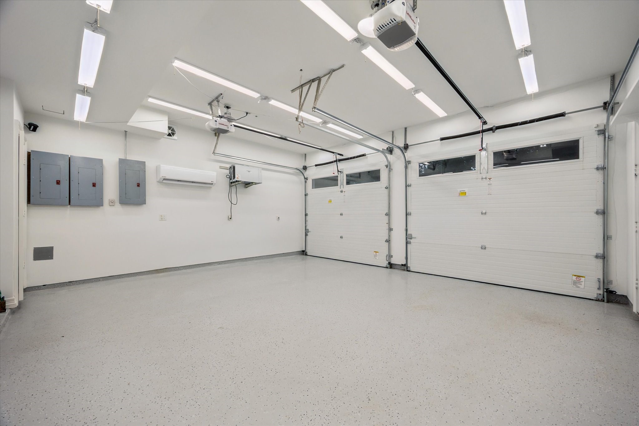 2249 Pelham Drive Houston, TX 77019 - Photo 48 of 50 Two-car garage with epoxy flooring and storage systems.