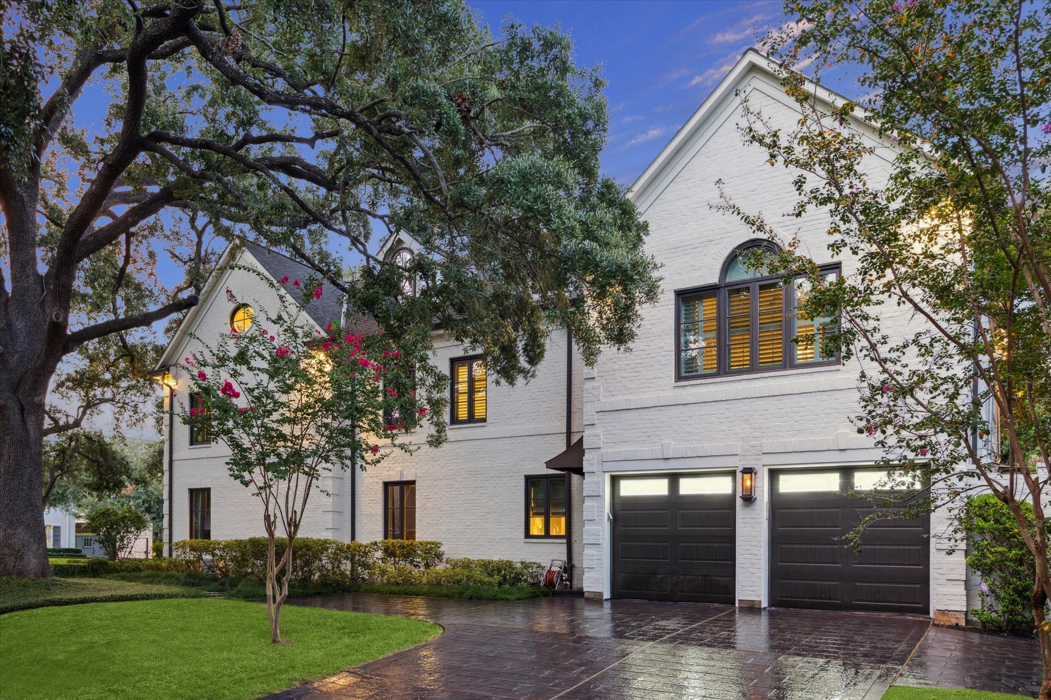 2249 Pelham Drive Houston, TX 77019 - Photo 49 of 50 Driveway view with lush landscaping, mature trees, and gated garage access.