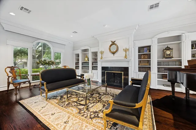 a living room with furniture a fireplace and a table