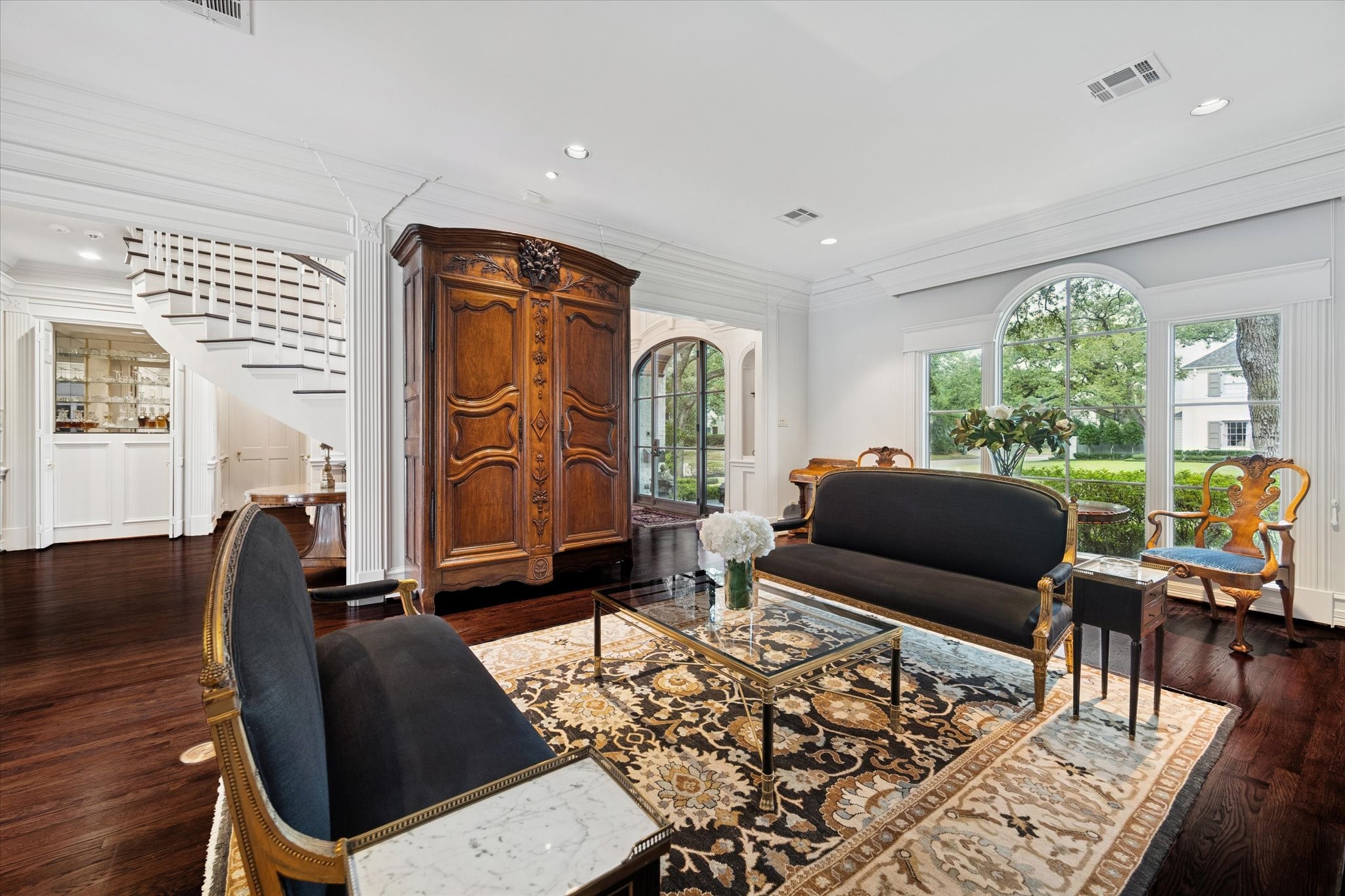 2249 Pelham Drive Houston, TX 77019 - Photo 6 of 50 Polished gathering space with timeless architectural details, elegant furnishings, and graceful sightlines flowing toward the grand staircase and garden views beyond.