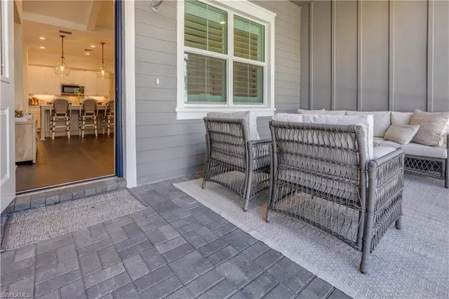 a view of backyard with barbeque grill and outdoor seating