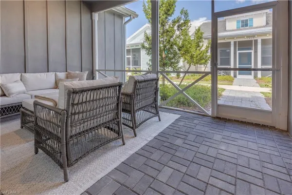 a view of a porch with furniture and garden