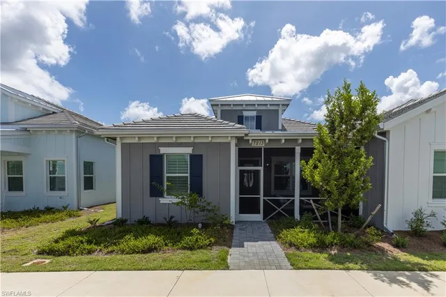 a view of a house with brick walls and flower plants
