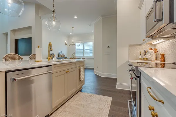 a kitchen with kitchen island a sink appliances and cabinets