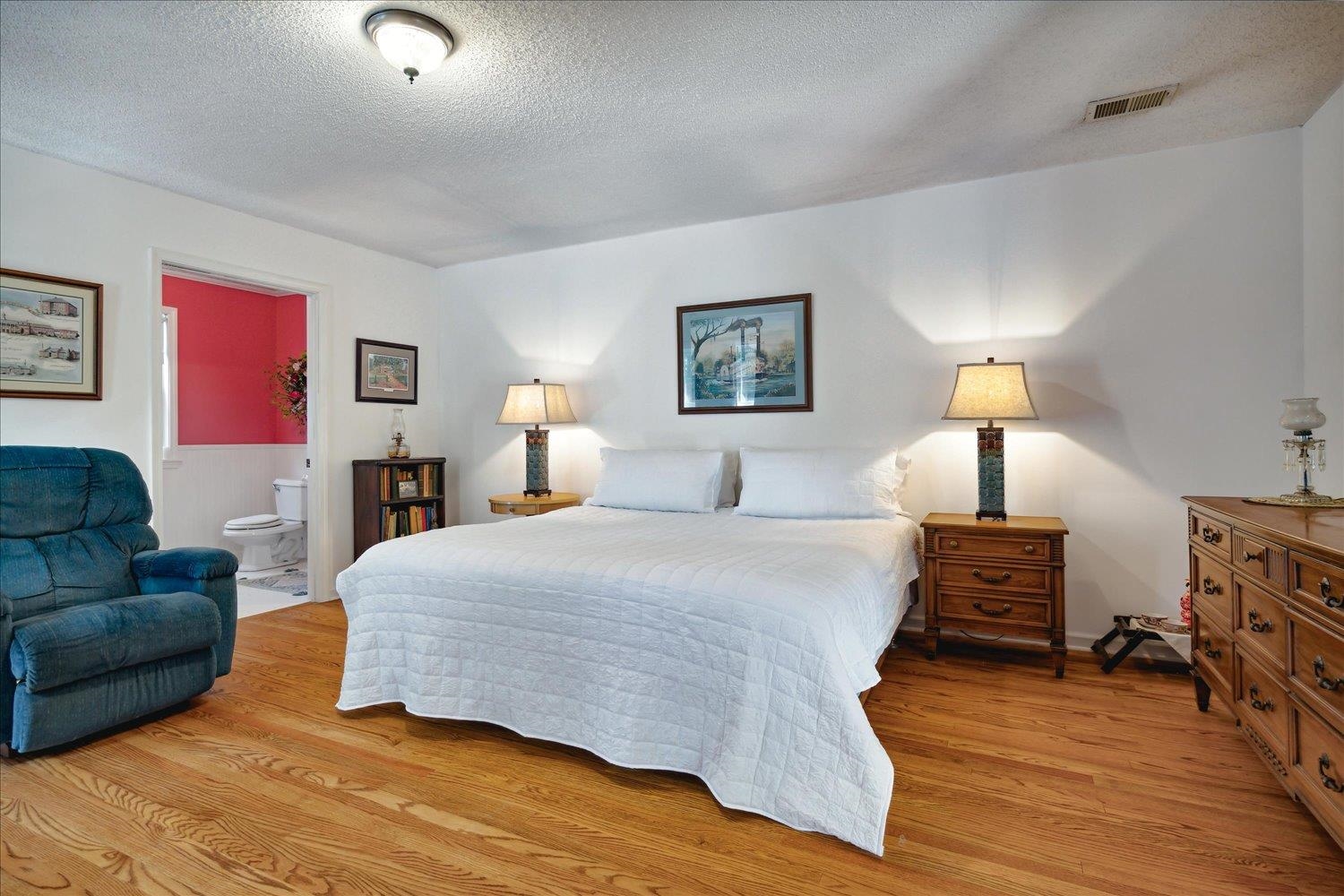 997 Vickers Road Big Sandy, TN 38221 - Photo 21 of 40 a bedroom with a bed a couch and dresser