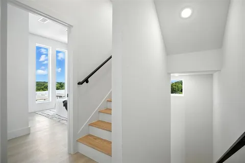 a view of entryway with wooden floor and stairs
