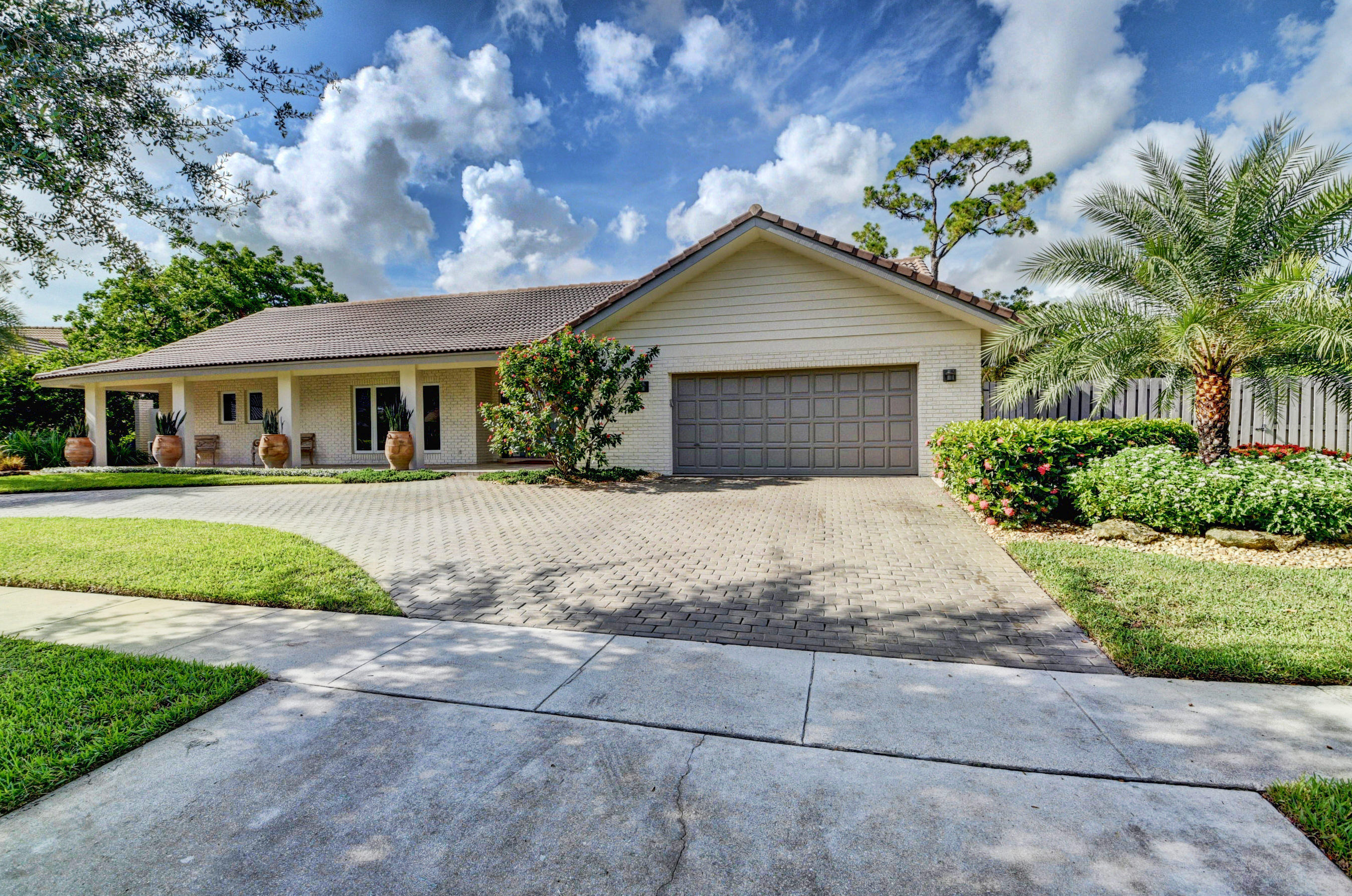 7624 Marbella Terrace Boca Raton, FL 33433 - Photo 2 of 55 a front view of a house with a yard and garage
