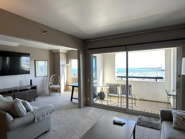 a living room with furniture and large windows