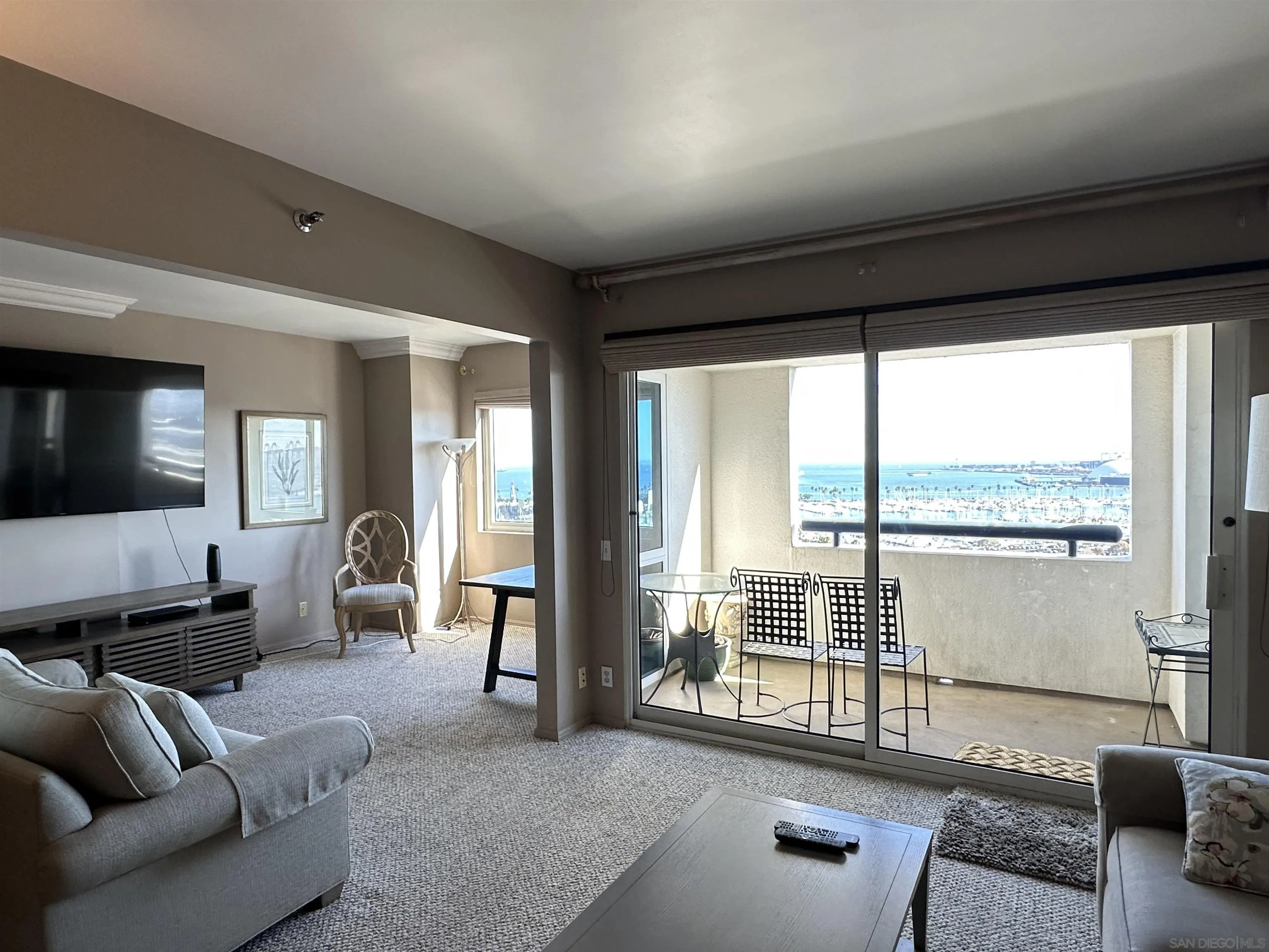 a living room with furniture and large windows
