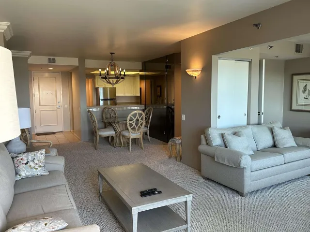a living room with furniture and a chandelier