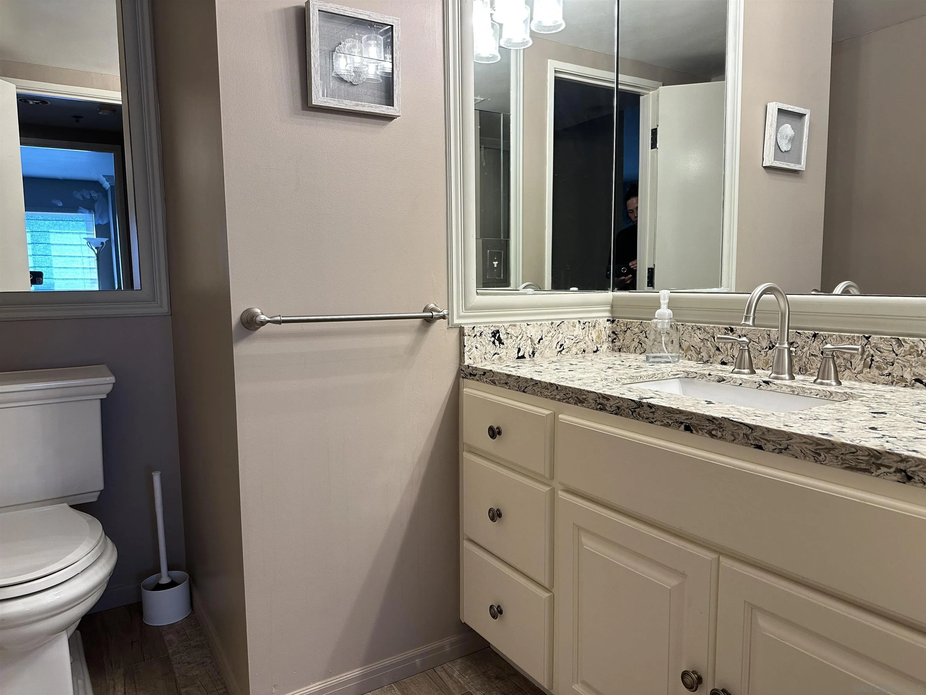 525 East Seaside Way, Unit 1607 Long Beach, CA 90802 - Photo 19 of 41 a bathroom with a granite countertop sink mirror vanity and toilet