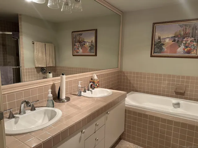 a bathroom with a sink mirror and a bathtub