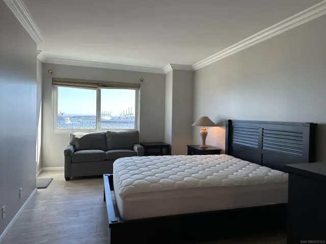 a bedroom with a bed and a couch