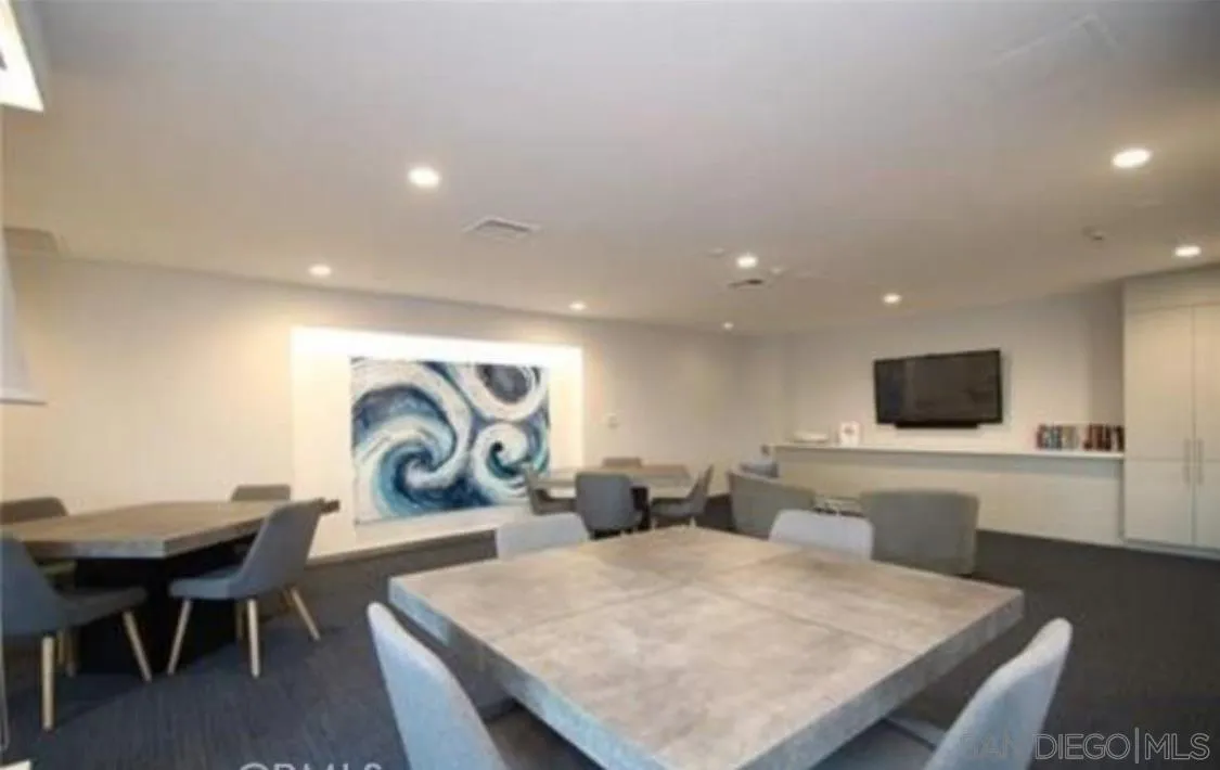 525 East Seaside Way, Unit 1607 Long Beach, CA 90802 - Photo 33 of 41 a living room with furniture a flat screen tv and kitchen view