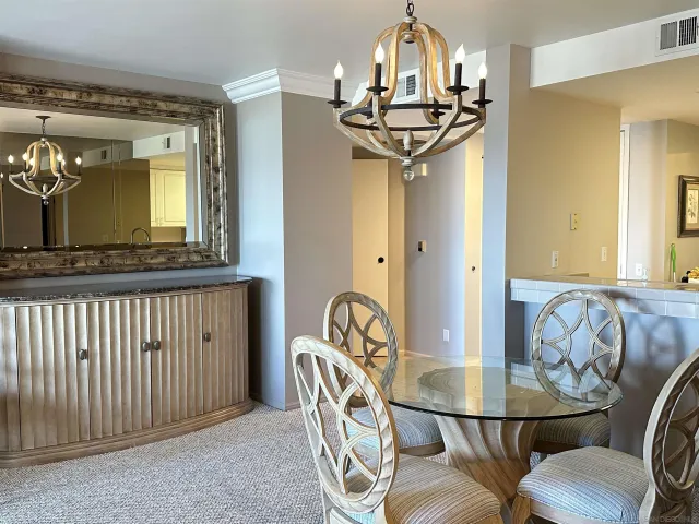 a view of a dining room with furniture and a chandelier