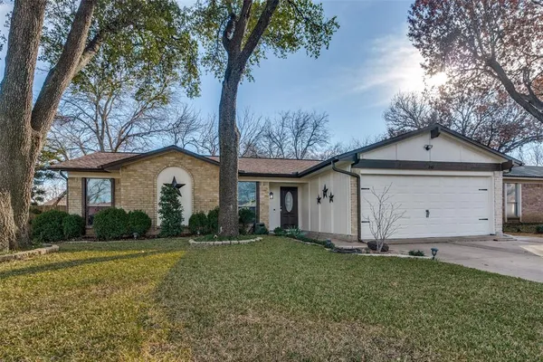 a front view of house with yard and trees