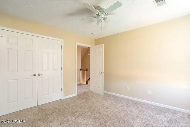 a view of a livingroom with a chandelier fan