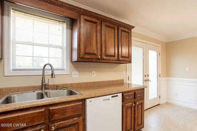 a kitchen with stainless steel appliances granite countertop a sink and a window