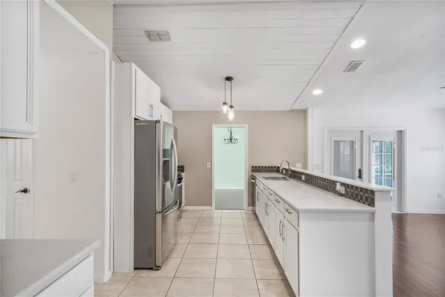 a kitchen with a sink and a chandelier